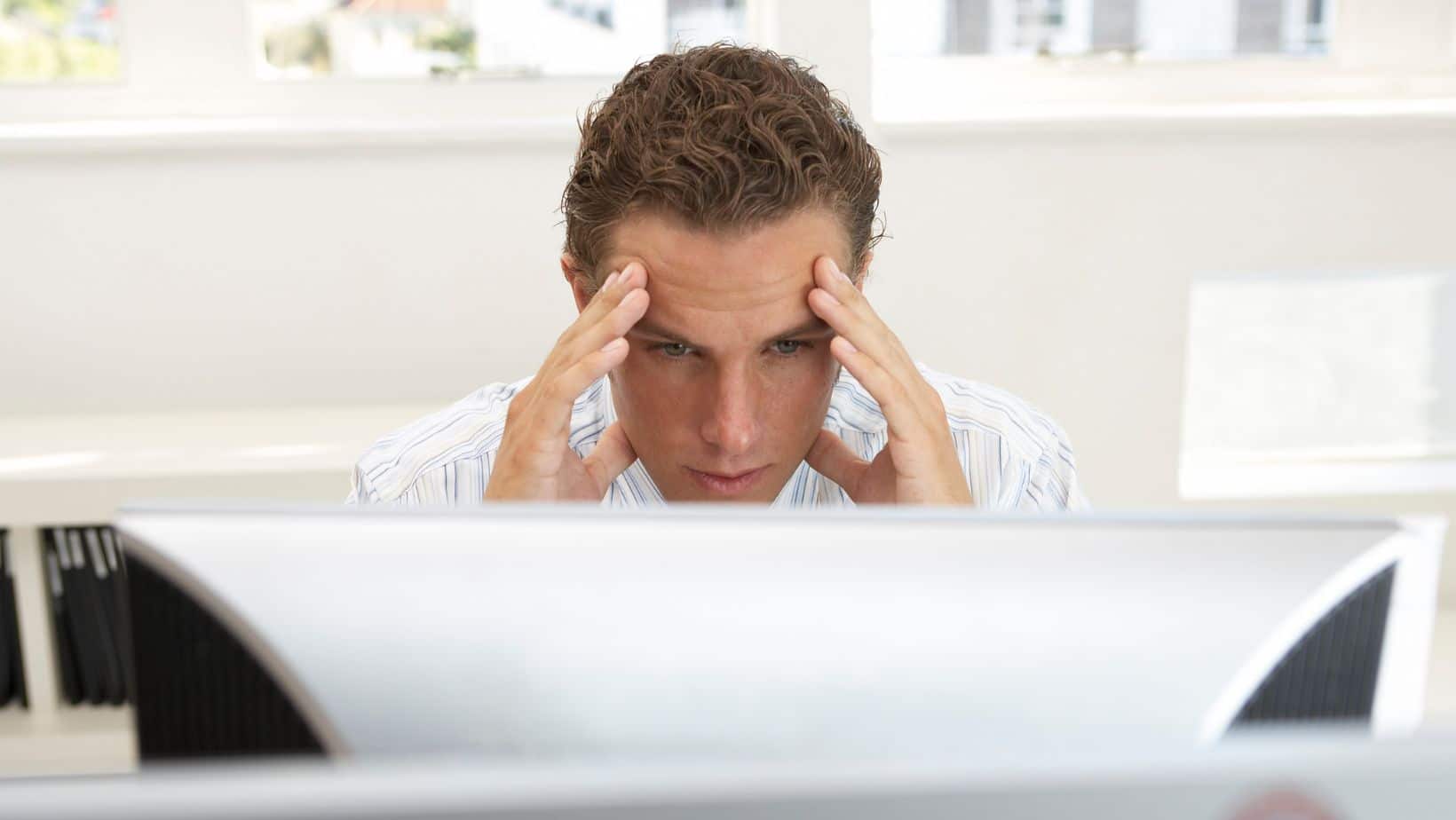 No website visitors? Frustrated man looks at computer screen.