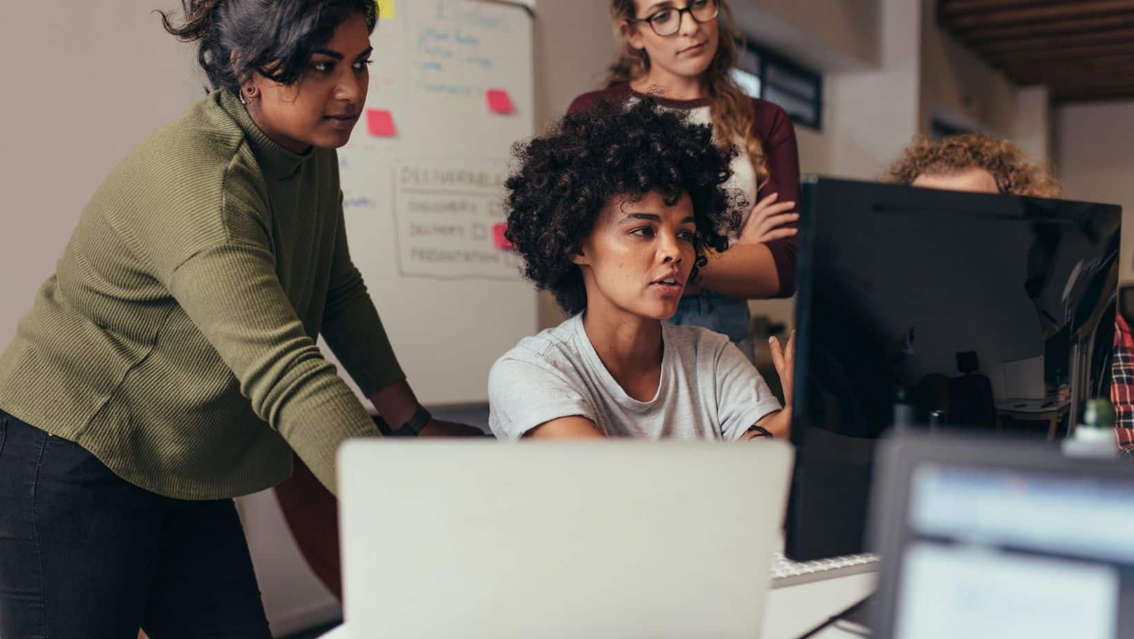 Web developers looking at a project on a computer