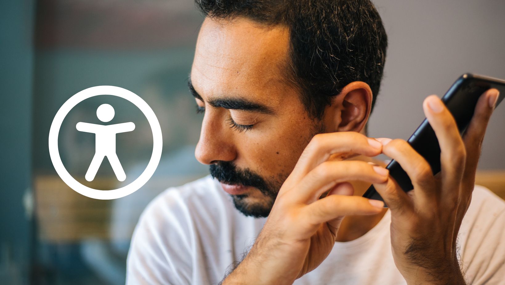 A man listening to an audio recording on his phone