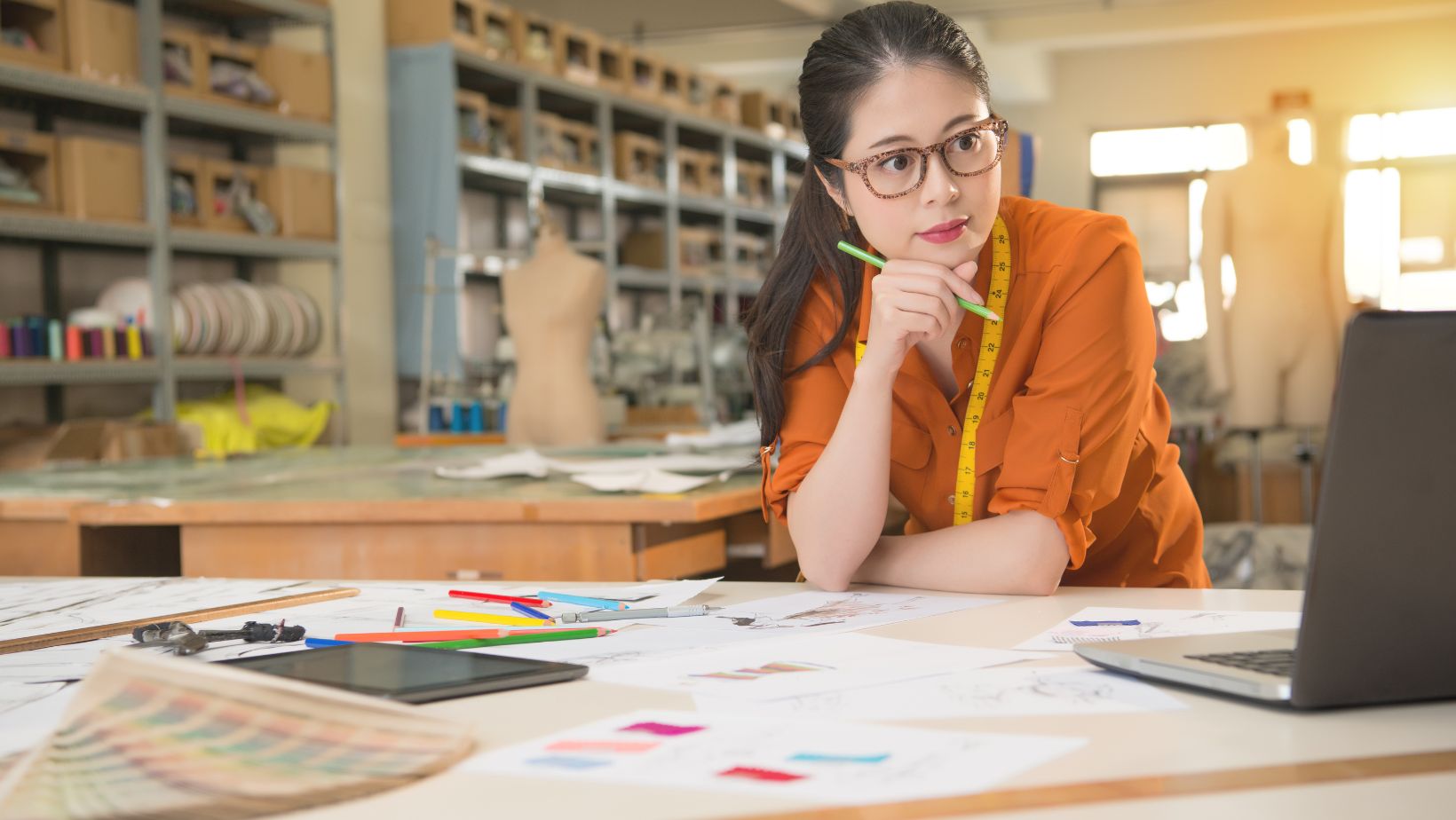 A fashion designer or tailor in her shop