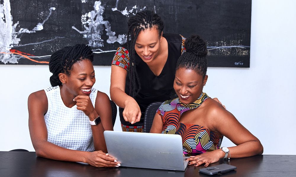 A small business team looking at their company website on a laptop