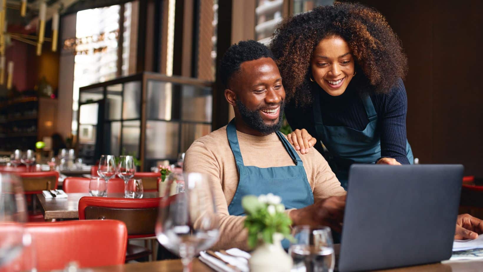 man and woman looking at the laptop