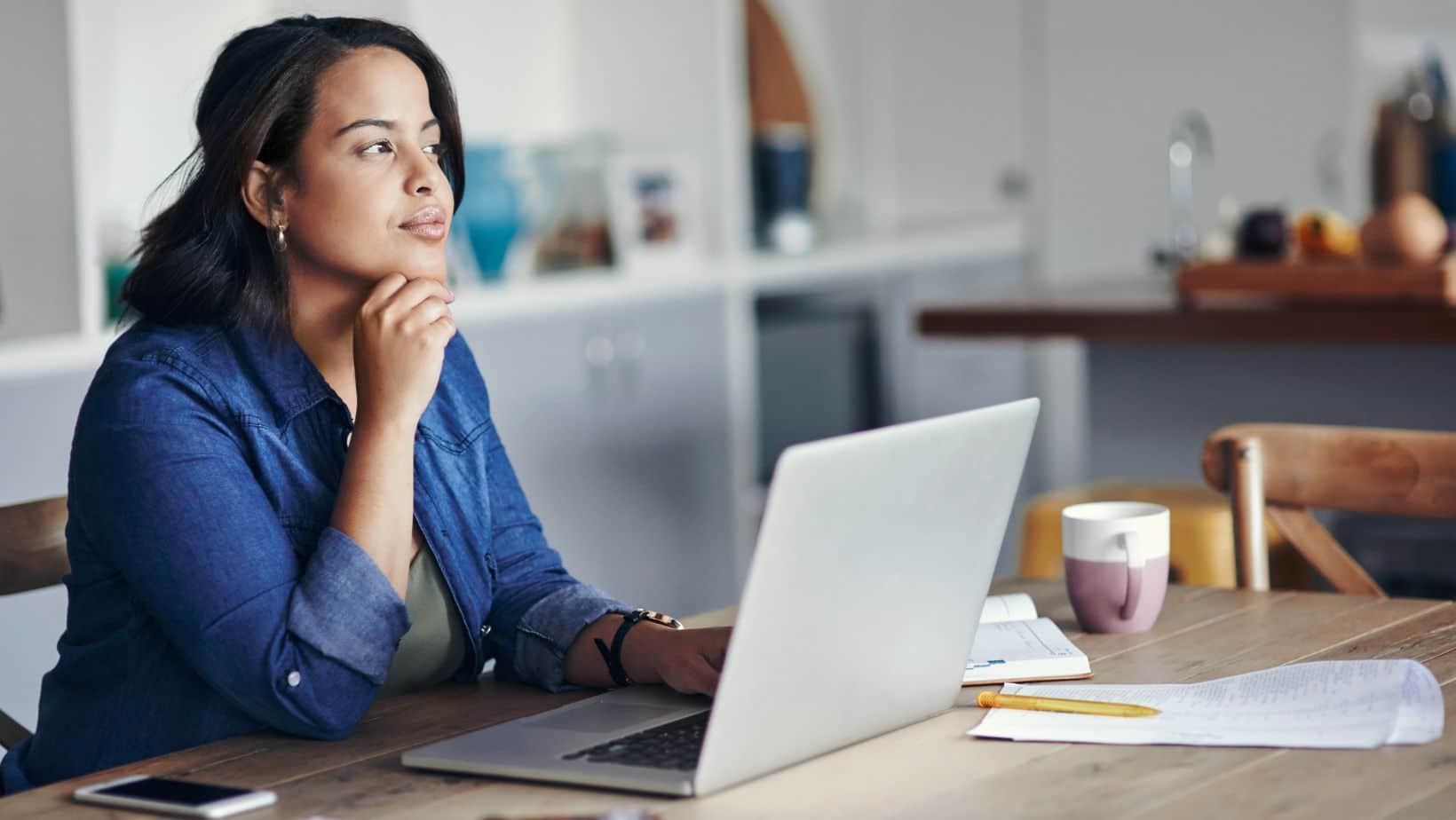 A woman thinking about revamping her website.