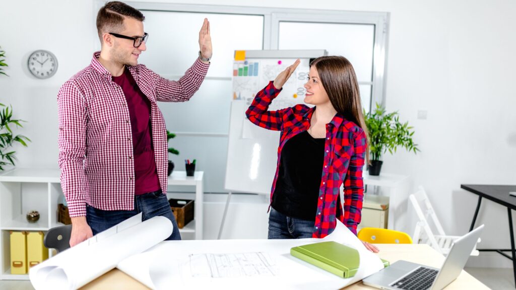 Two people giving each other high fives