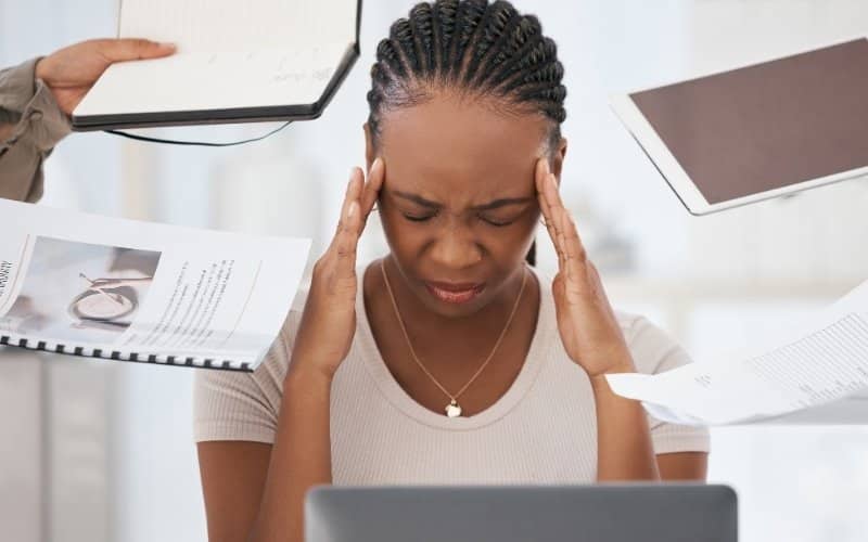 An overwhelmed business owner feeling the pressure of numerous priorities.