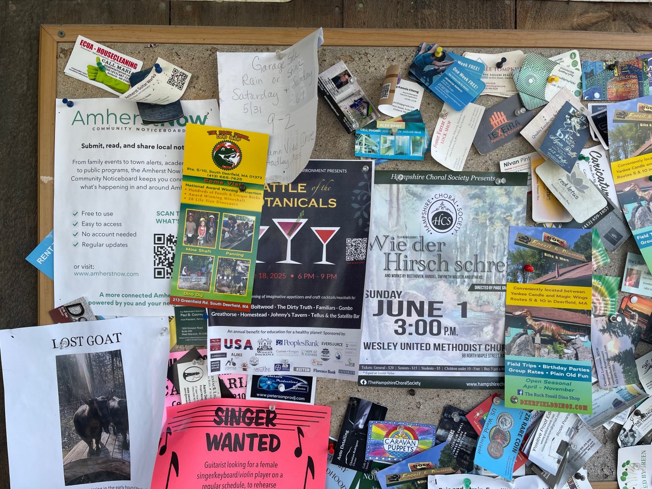 Community Bulletin Board at Flayvors of Cook Farm showing Amherst Now flyer.